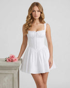 Lauven Luna Mini Dress in white cotton blend with structured bodice and pleated skirt, perfect for summer occasions.