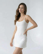 Luna Mini Dress by Lauven, a sleek white knitted camisole dress with ribbed texture and slim fit.