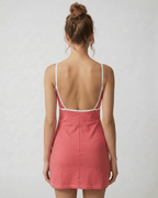 Back view of the Lauven Luna Mini Dress in vibrant pink, showcasing its cut-out detail and slim fit design.