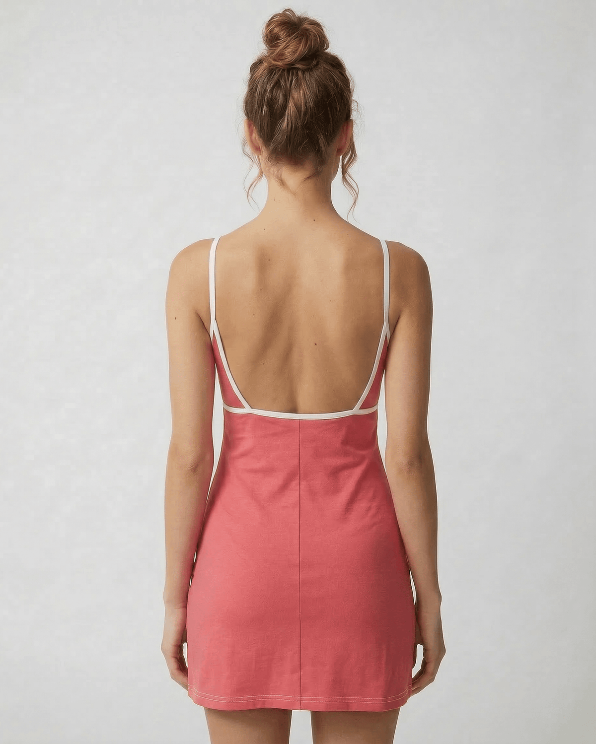Back view of the Lauven Luna Mini Dress in vibrant pink, showcasing its cut-out detail and slim fit design.