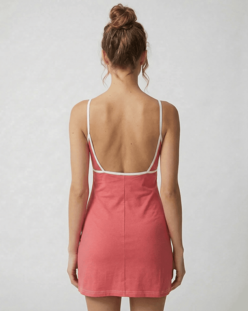 Back view of the Lauven Luna Mini Dress in vibrant pink, showcasing its cut-out detail and slim fit design.