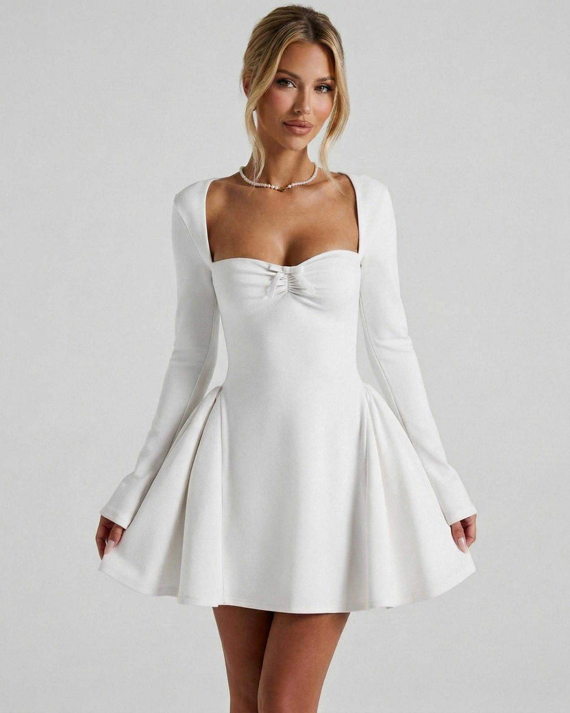 Lauven Luna Mini Dress featuring a square neckline, ruched bow detail, and long fitted sleeves in classic white.