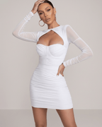 Luna Mini Dress by Lauven in crisp white with sheer long sleeves and a cut-out sweetheart neckline.