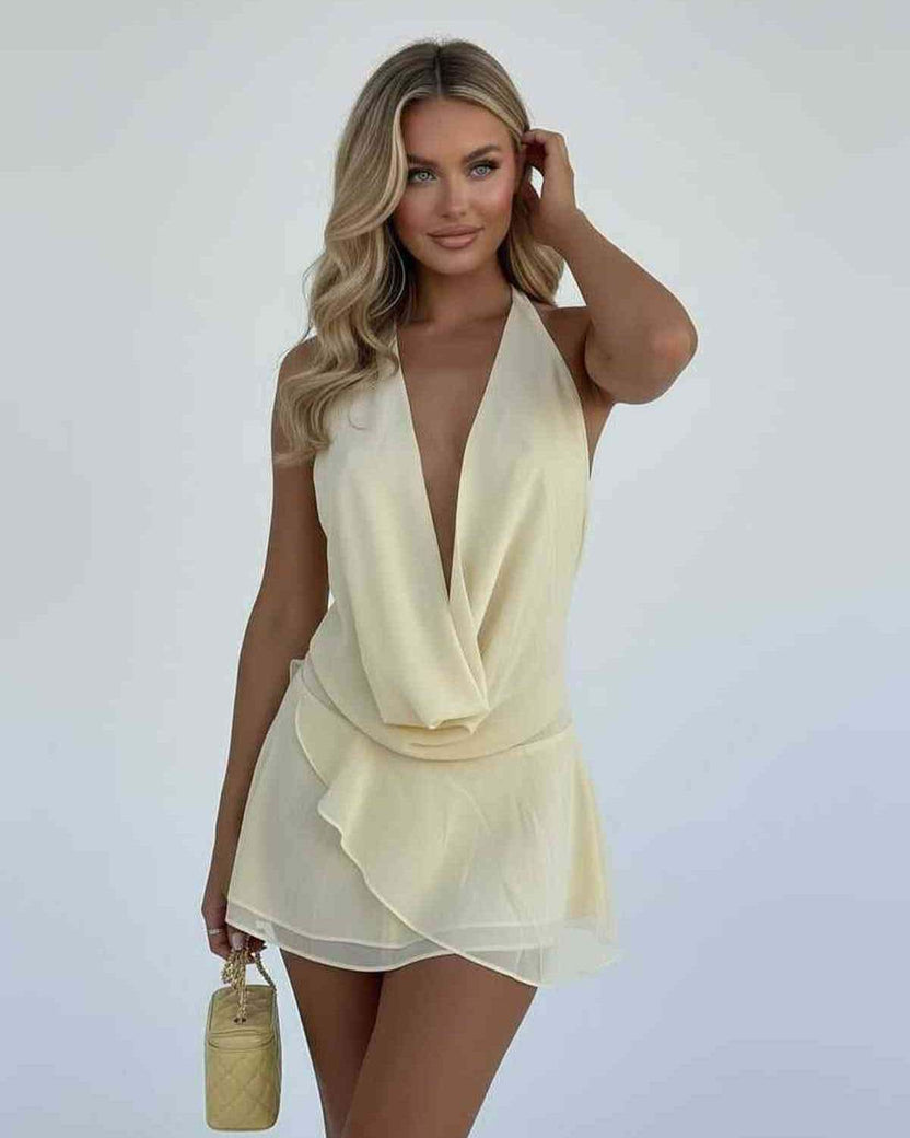 Model wearing the Luna Mini Dress by Lauven, showcasing a chiffon draped silhouette in soft yellow.