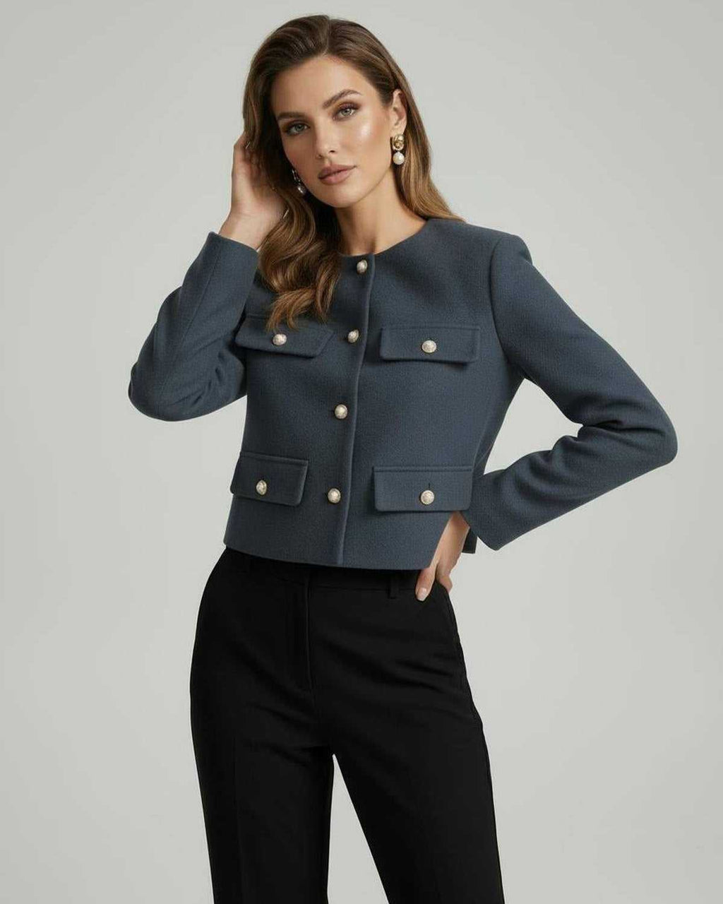 Marina Jacket by Lauven in slate blue with gold button details and cropped silhouette worn by a model.