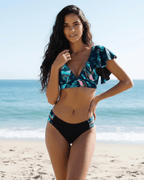 Model wearing Lauven Maris Two-Piece Swimsuit with floral print and deep V-neckline at the beach.