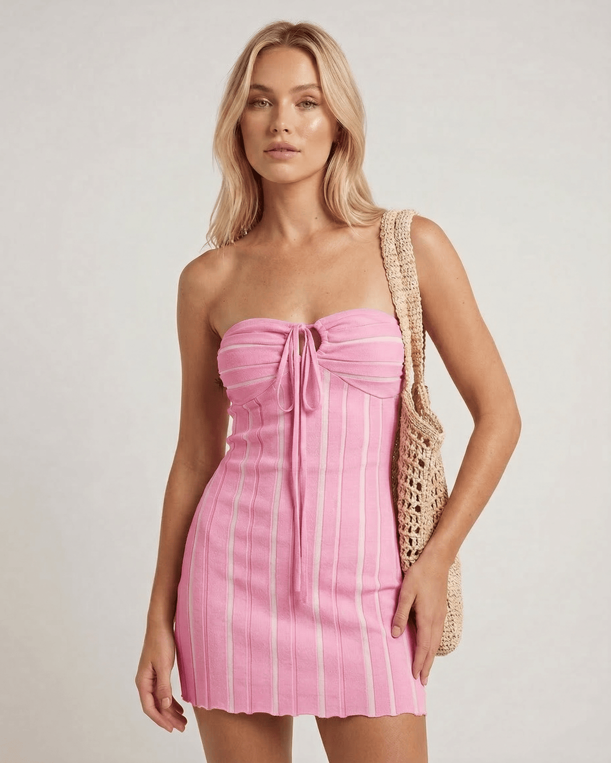 Mila Mini Dress by Lauven, soft pink knitted halter neck mini dress with ribbing and adjustable tie detail.