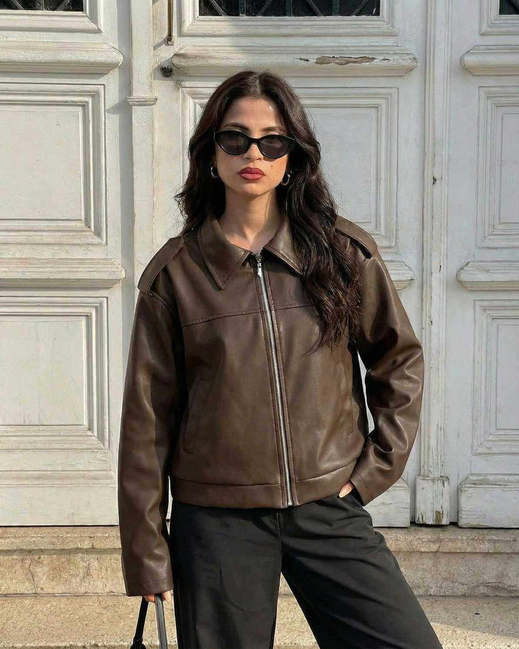 Model wearing Milano Jacket by Lauven, a stylish women's brown leather jacket for fall streetwear.