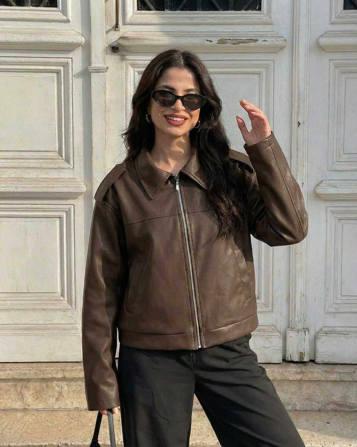 Woman wearing Milano Jacket by Lauven, a stylish brown leather jacket for fall streetwear and casual style.
