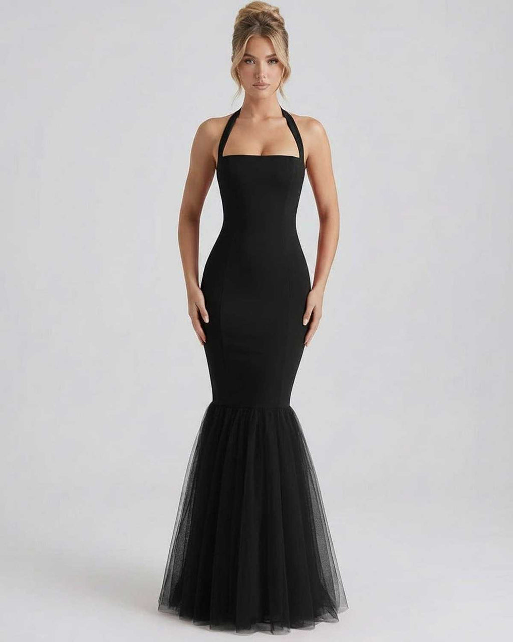 Monaco Maxi Dress by Lauven, black halter neck bodycon dress with tulle hem, offers elegance and a flattering silhouette.
