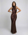 Monaco Maxi Dress by Lauven: Elegant brown satin dress with halter neck and open back, exuding refined sophistication.