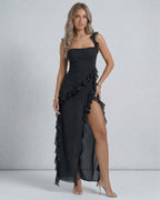 Lauven Nocturne Maxi Dress in black with sheer ruffles and thigh-high slit, elegant summer fashion.