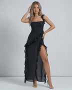 Lauven Nocturne Maxi Dress featuring sheer ruffles, thigh-high slit, and elegant black chiffon fabric.