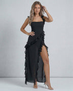 Lauven Nocturne Maxi Dress featuring ruffled straps, thigh-high slit, and asymmetric hemline in black chiffon.