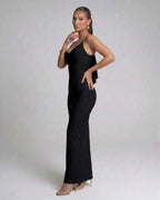 Model showcasing the Nocturne Maxi Dress by Lauven, a classic black spaghetti strap evening gown.