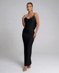 Model wearing the Nocturne Maxi Dress by Lauven, a classic black spaghetti strap evening gown.