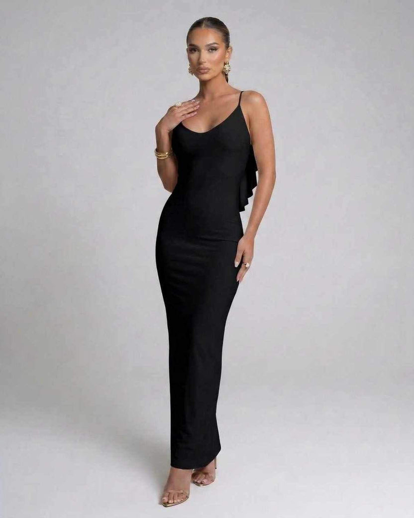 Model wearing the Nocturne Maxi Dress by Lauven, a classic black spaghetti strap evening gown.