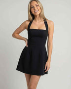 Lauven Noella Mini Dress with halterneck and A-line silhouette, showcasing a flattering backless design.