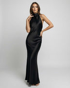 Noir Maxi Dress by Lauven, featuring a sleek satin finish, halter neck design, refined structure and fluid drape.