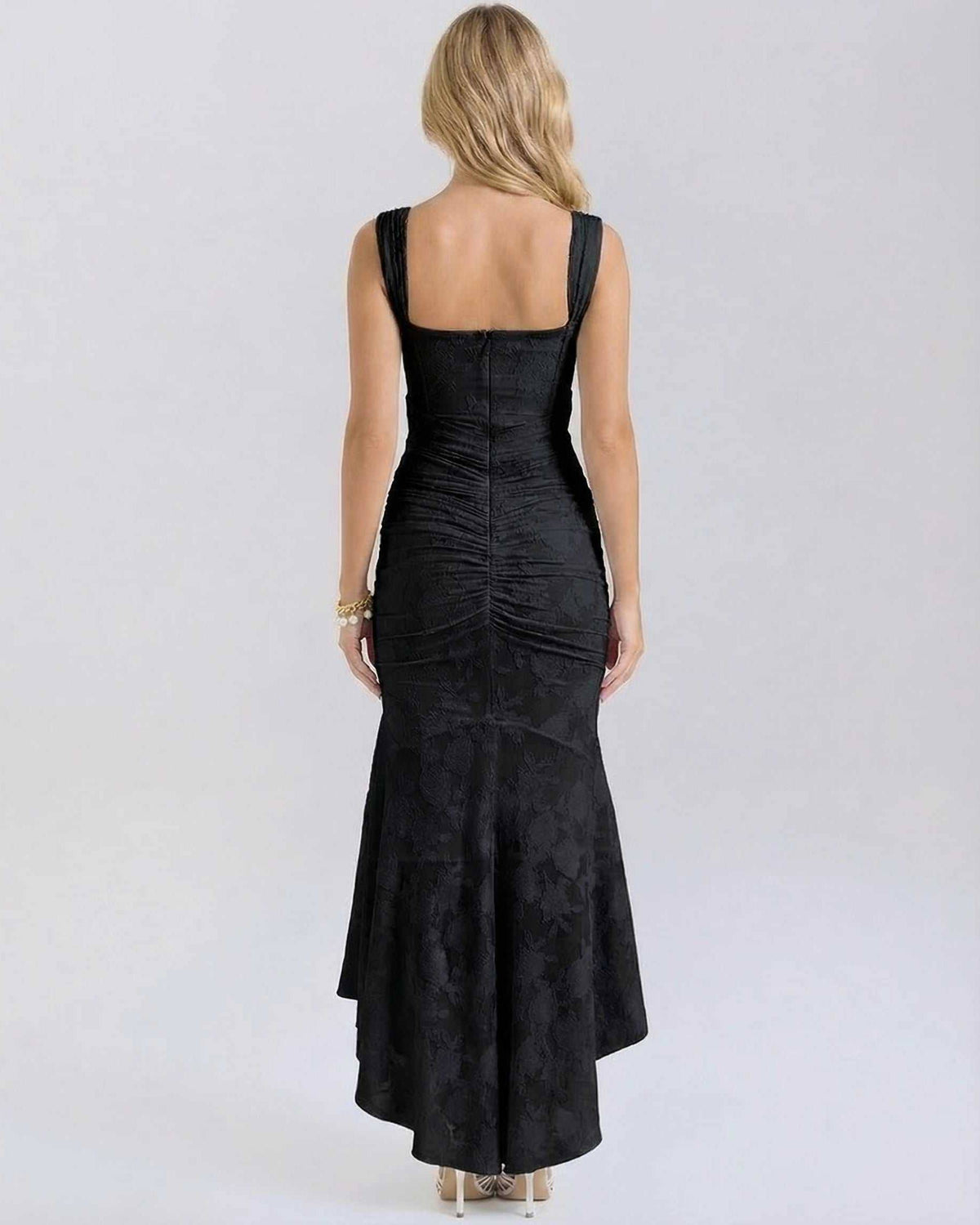 Noir Maxi Dress by Lauven showing back view with pleated details and fish tail hem in black.