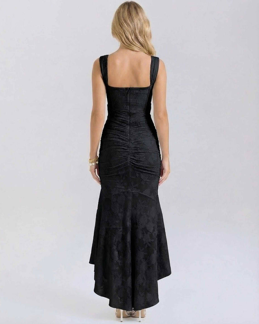 Noir Maxi Dress by Lauven showing back view with pleated details and fish tail hem in black.