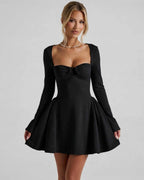 Noir Mini Dress featuring a square neckline, long sleeves, and ruched bow detail by Lauven.