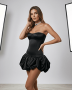 Model wearing Noir Mini Dress by Lauven, a sleek black strapless bodycon dress with an open back.