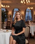 Lauven Noir Mini Dress with satin finish, ruffle hem, and tie waist, perfect for elegant dining occasions.