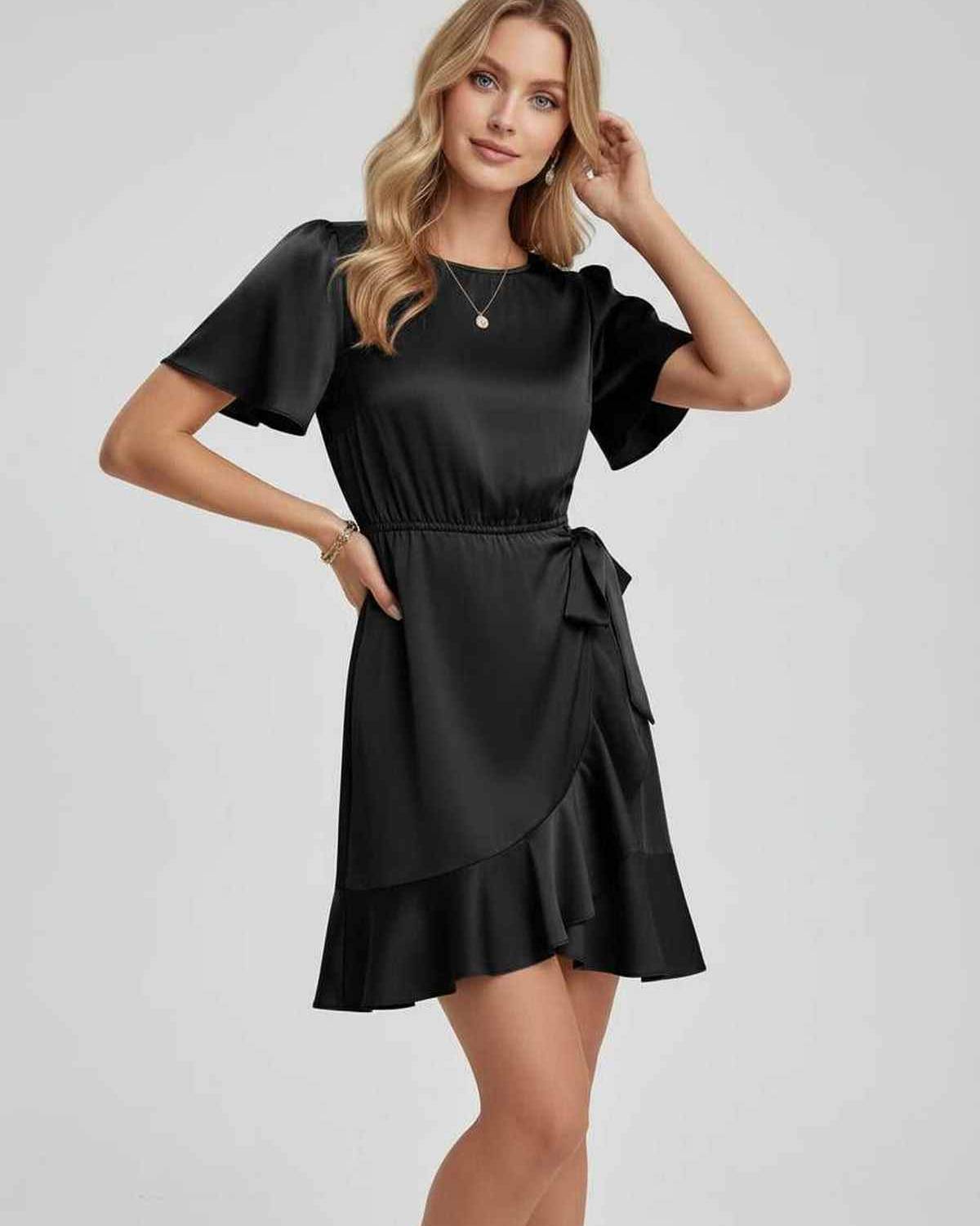 Lauven Noir Mini Dress featuring sleek satin finish, ruffle hem, and flattering tie waist design.