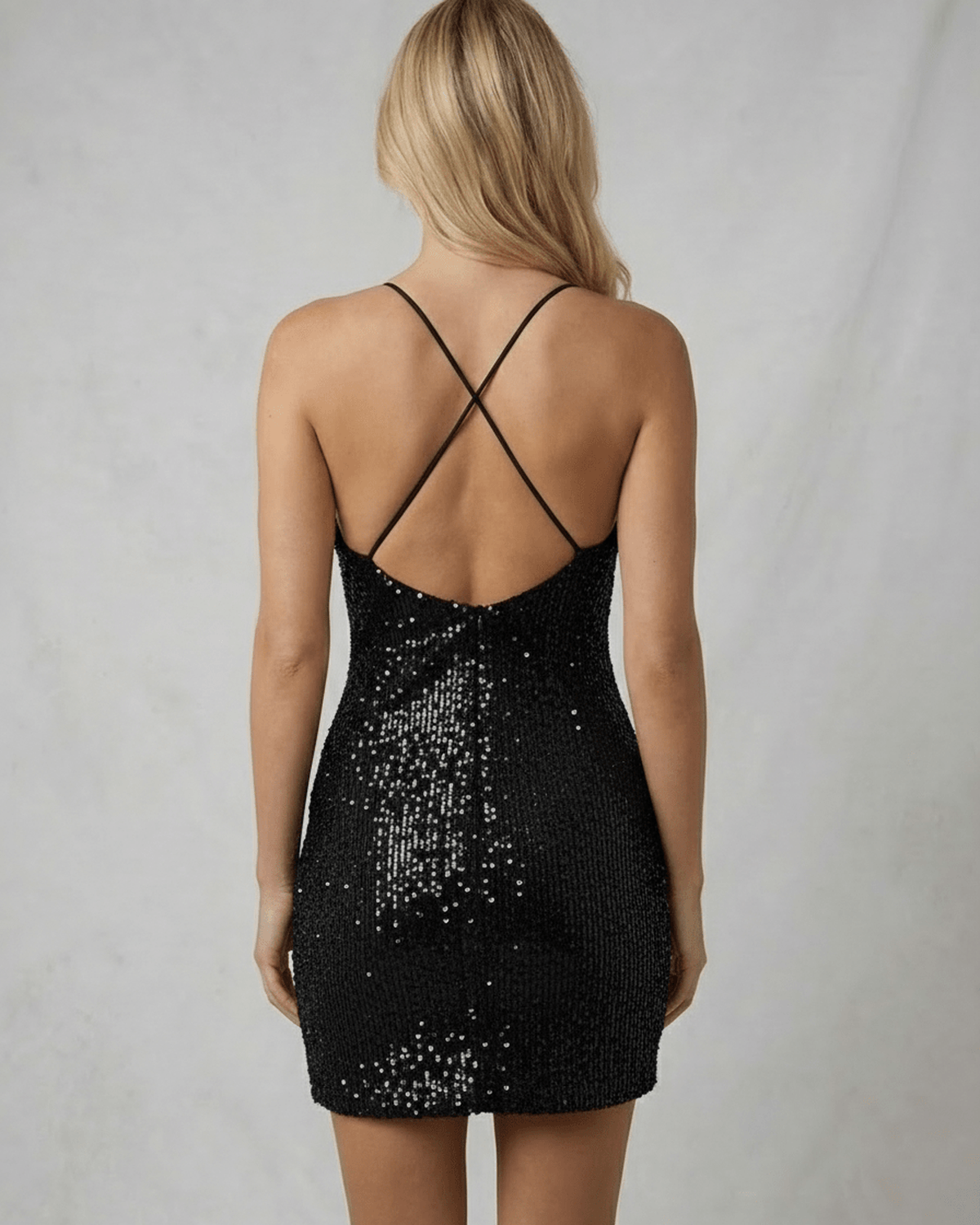 Back view of Noir Mini Dress by Lauven, highlighting its sleek sequin design and crisscross straps.