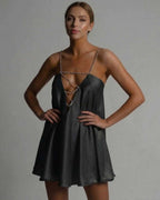 Noir Mini Dress by Lauven, featuring a flared satin silhouette with beaded straps and a V-neckline.