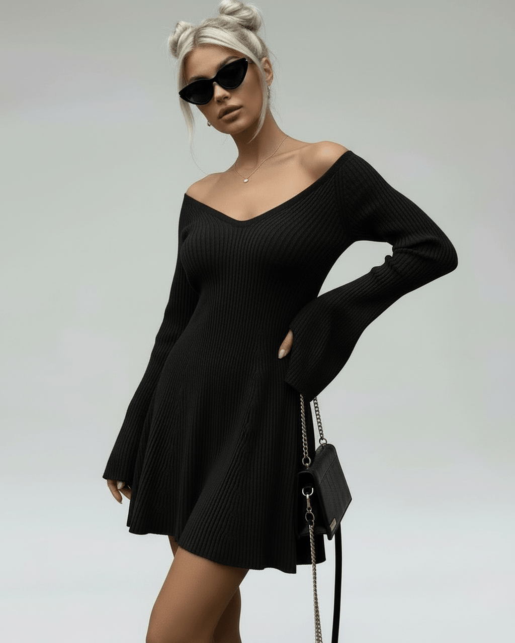 Model wearing a Lauven Noir Mini Dress, a slim fit black knit with V-neck and flared sleeves.