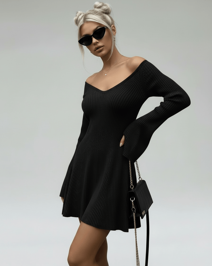 Model wearing Noir Mini Dress by Lauven, a slim fit black knitted dress with V-neckline and flared sleeves.