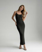 Model wearing Noiré Midi Dress, a sleek black sleeveless bodycon dress by Lauven, showcasing elegance and modern sophistication.