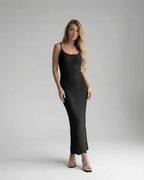 Noiré Midi Dress on a model, showcasing its sleek sleeveless silhouette and sculpted bodycon fit by Lauven.