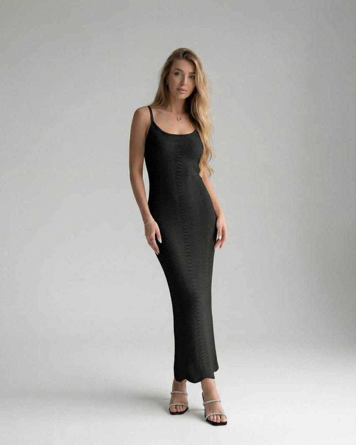 Noiré Midi Dress on a model, showcasing its sleek sleeveless silhouette and sculpted bodycon fit by Lauven.