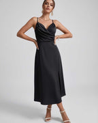 Noiré Midi Dress by Lauven - Elegant black satin dress with spaghetti straps, cowl neck, and refined silhouette.