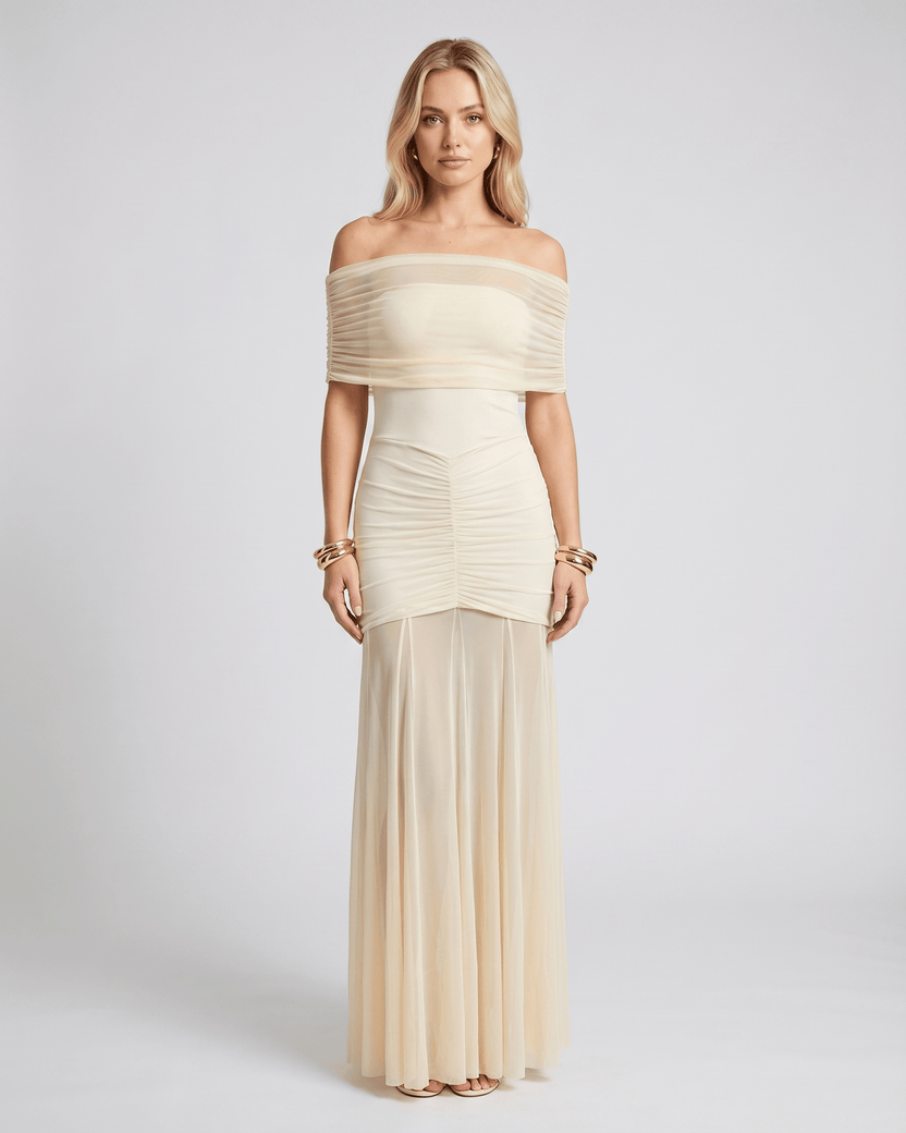 Noirline maxi dress by Lauven, featuring off-shoulder neckline, ruched bodice, elegant flowing sheer panel, and stunning movement.
