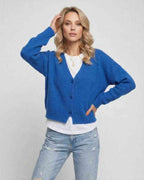 Model wearing a vibrant blue Nova Cardigan from Lauven, showcasing its relaxed fit and cozy knit style.