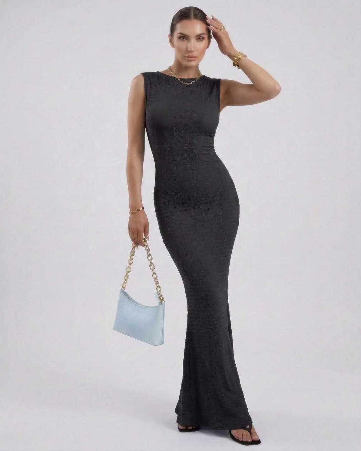 Model wearing a Nova Maxi Dress by Lauven, a black sleeveless ankle-length pencil dress with a sleek silhouette.