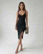 Nova Midi Dress, elegant black sheath with side slit, crafted by Lauven, offers comfort and modern style.