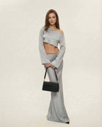 Model wearing Nova Midi Dress by Lauven, featuring an elegant asymmetrical silhouette in sleek silver.