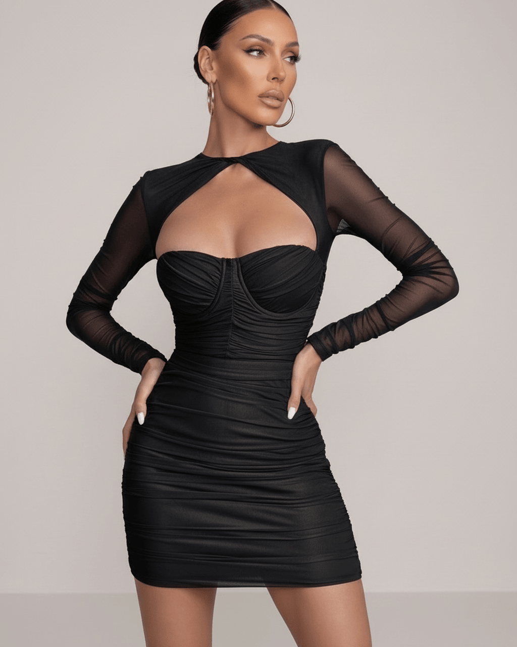 Nova Mini Dress by Lauven in classic black with sheer long sleeves and ruched bodice detailing.