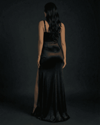Nyx Maxi Dress by Lauven, showcasing a refined black mermaid silhouette with a chic slit from the back.