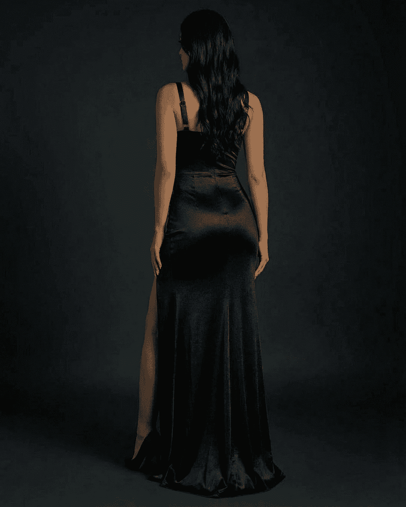 Nyx Maxi Dress by Lauven, showcasing a refined black mermaid silhouette with a chic slit from the back.