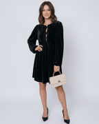 Onyx Mini Dress by Lauven featuring a sleek black velvet design with drawstring detail and elegant long sleeves.