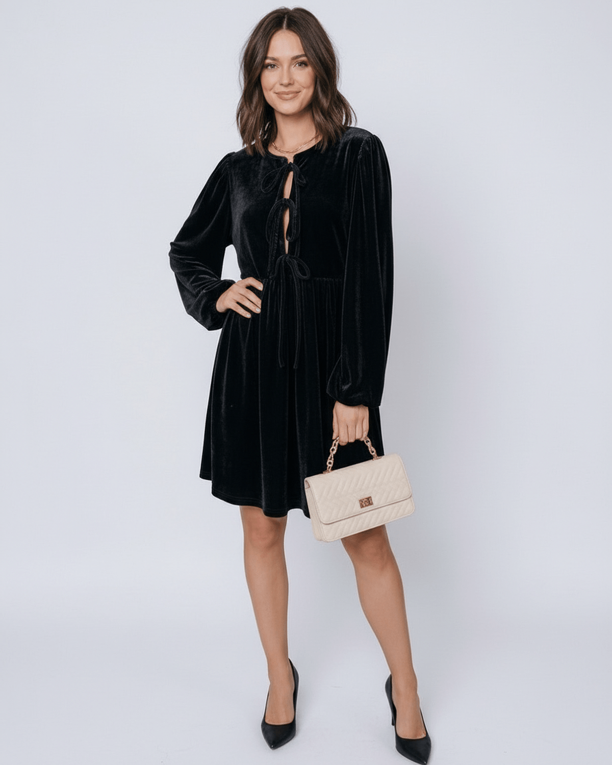 Onyx Mini Dress by Lauven featuring a sleek black velvet design with drawstring detail and elegant long sleeves.