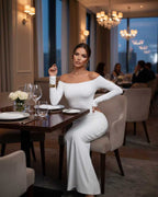 Orion Maxi Dress by Lauven in classic white, showcasing sleek off-shoulder long sleeves and a flattering silhouette.