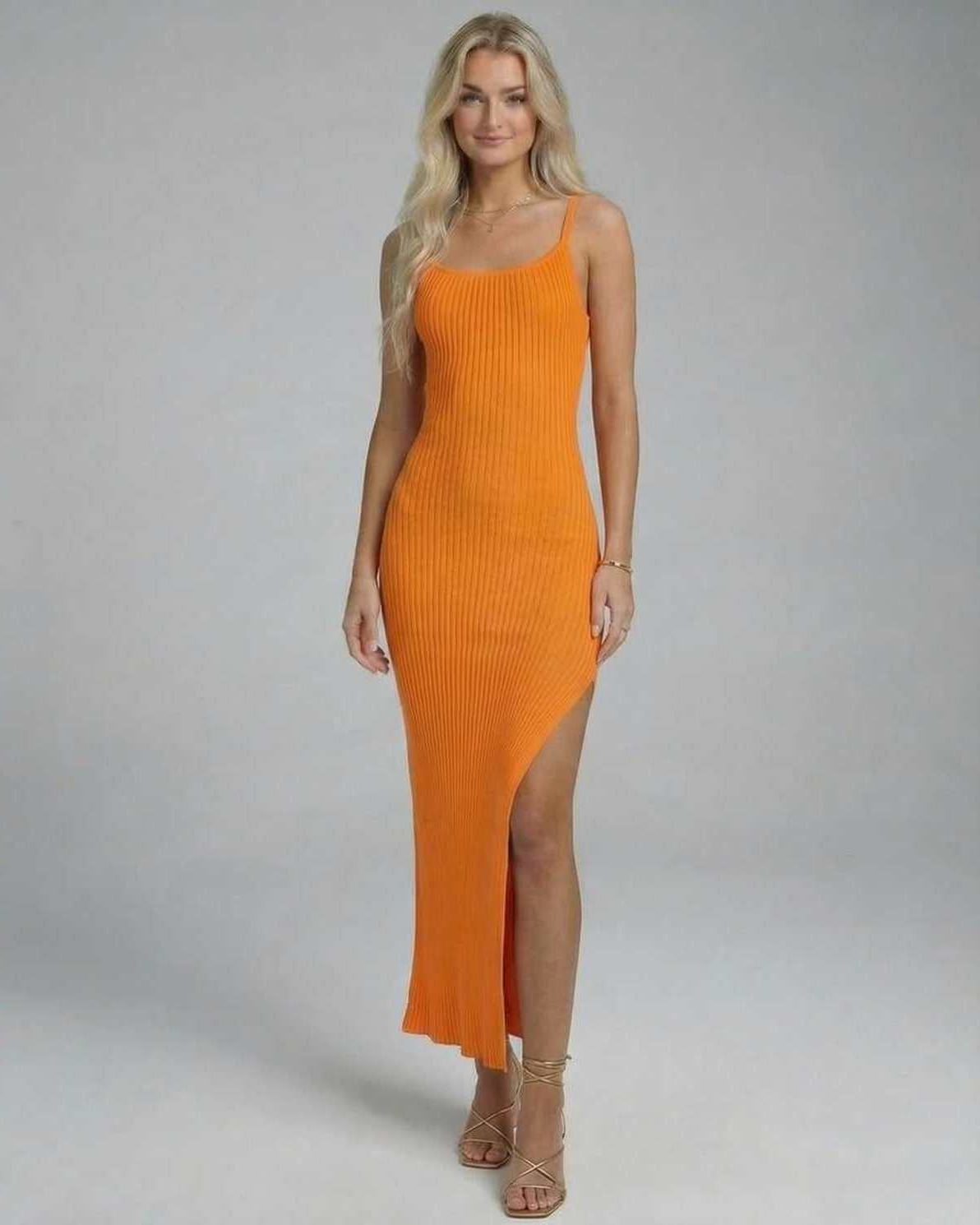Orion Midi Dress by Lauven in vibrant orange, showcasing a sleek knitted design with a high slit.
