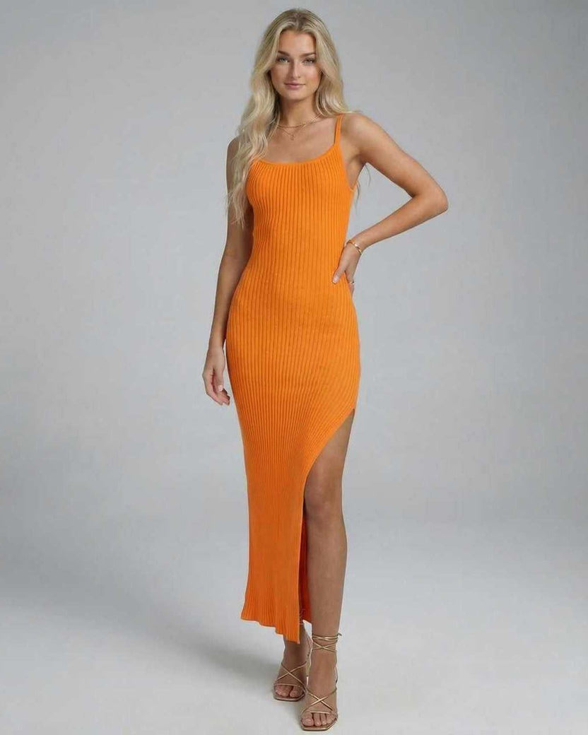 Elegant woman wearing the Orion Midi Dress by Lauven, featuring a sleek, stretchy knitted design and high slit.